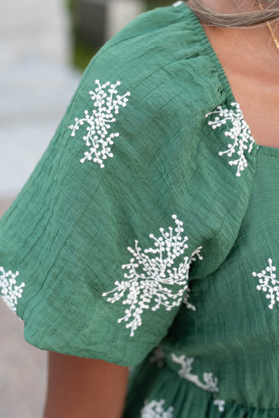 Close up of the sleeve on the emerald green embroidered dress