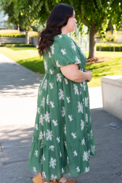 Side view of the plus size emerald green embroidered dress