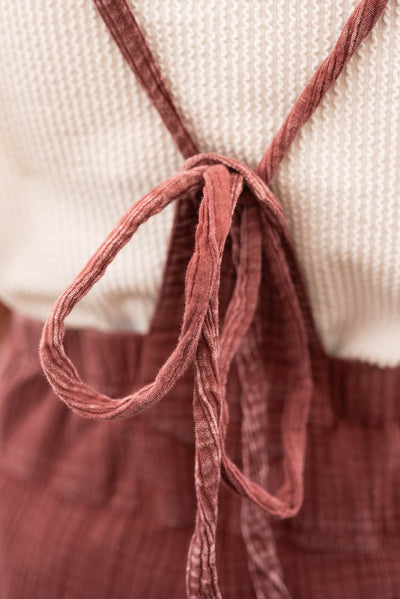 The ties on the back of the faded plum washed overalls