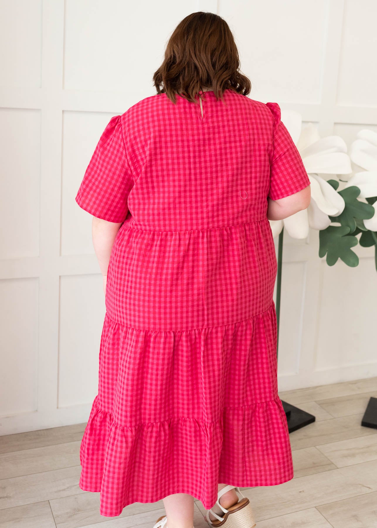 Back view of the plus size hot pink gingham tiered dress