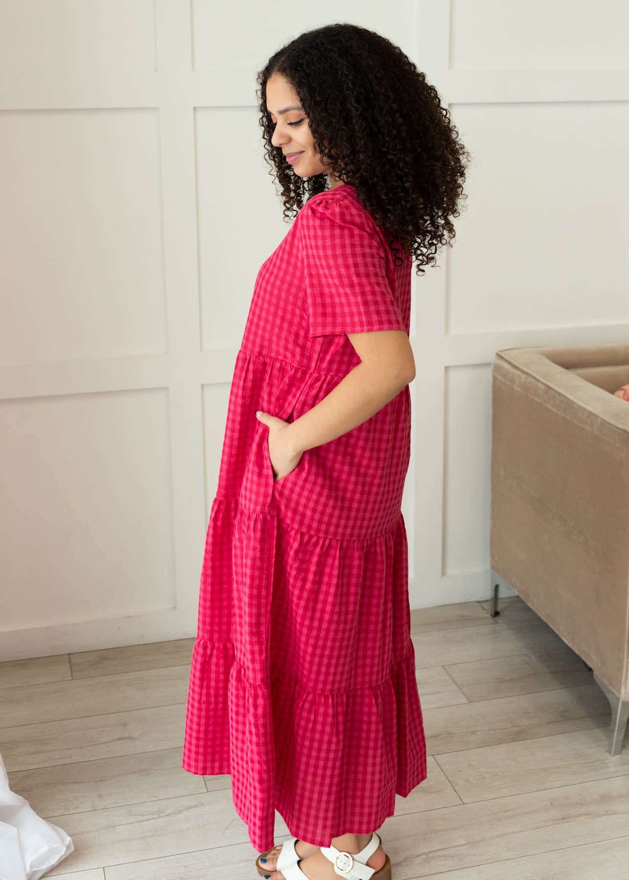 Side view of the hot pink gingham tiered dress with pockets