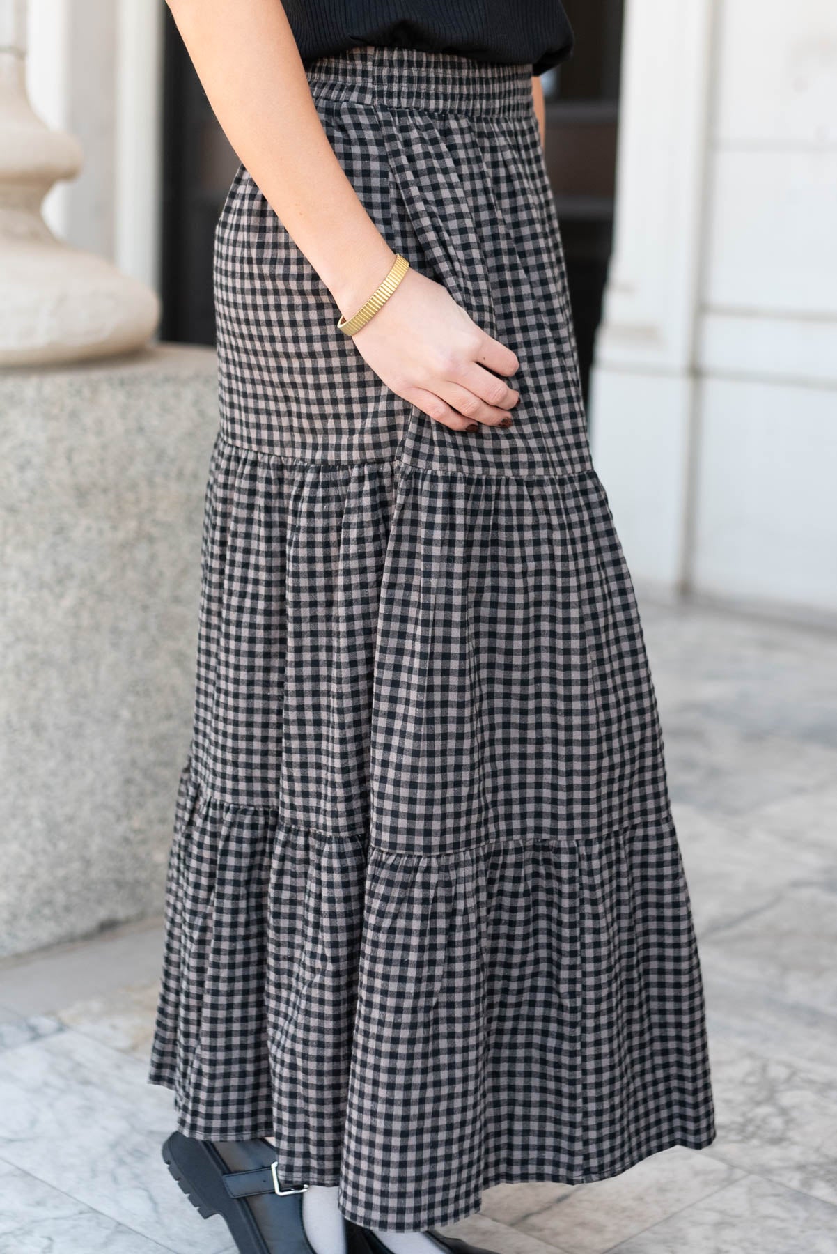 Side view of the black gingham skirt with pockets