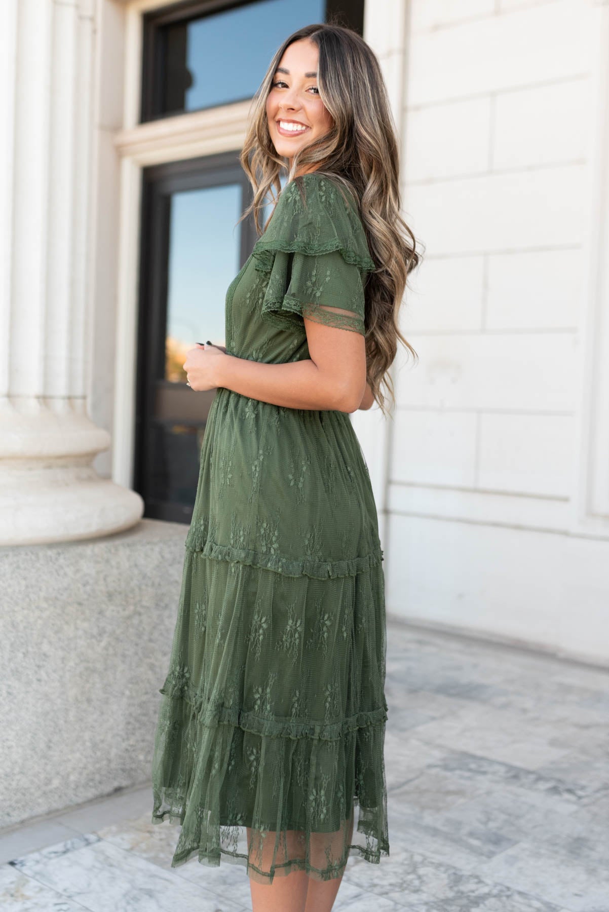 Side view of the dark green floral lace dress