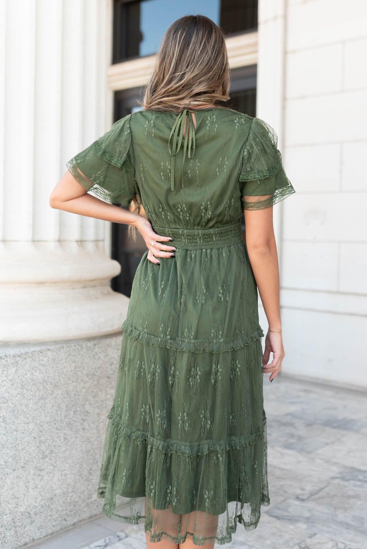 Back view of the dark green floral lace dress