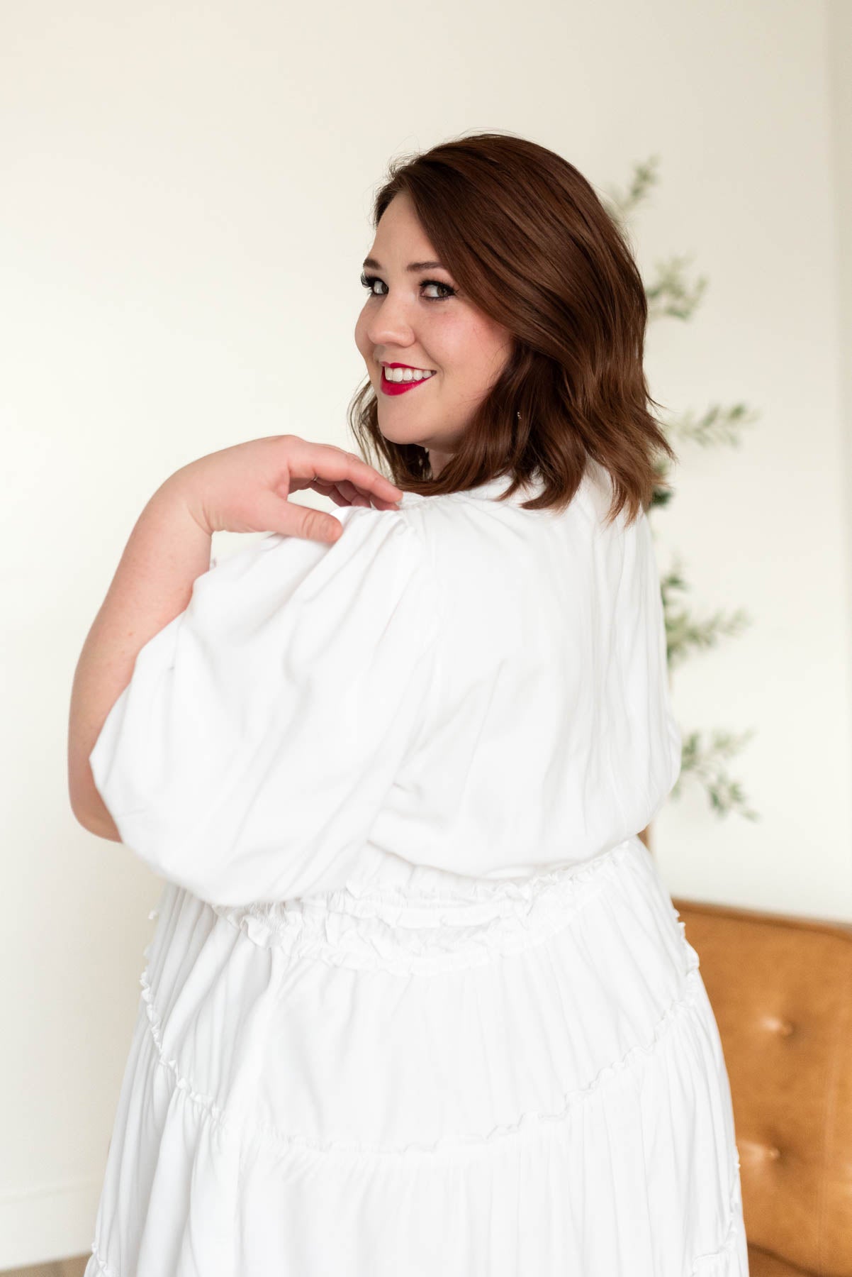 Close up of the puff sleeve on the ivory v neck dress in plus size