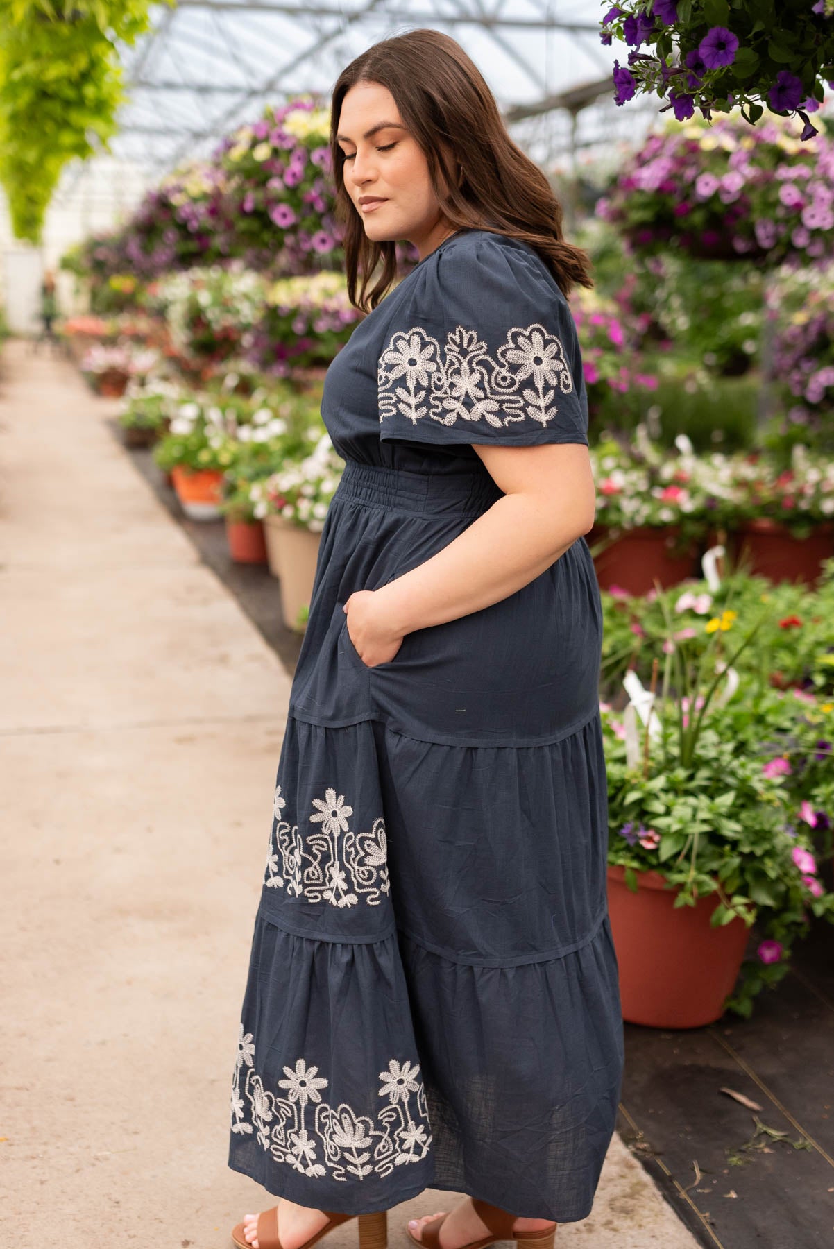 Side view of the navy embroidered detailed dress