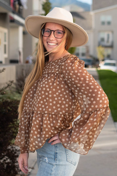 Side view of a brown floral top