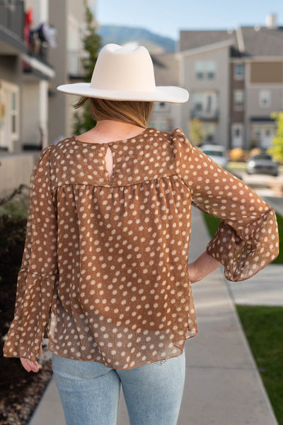 Back view of a brown floral top