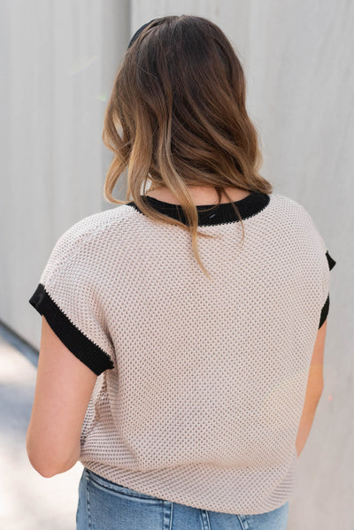 Back view of the beige black trim sweater