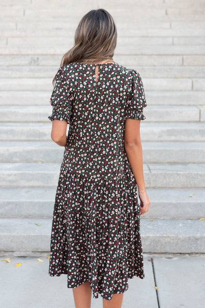 Back view of the tiered floral dress with button closer loop