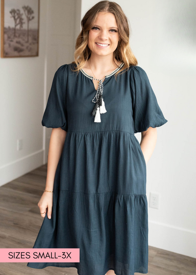 Navy tie dress with trim and a tie at the neckline