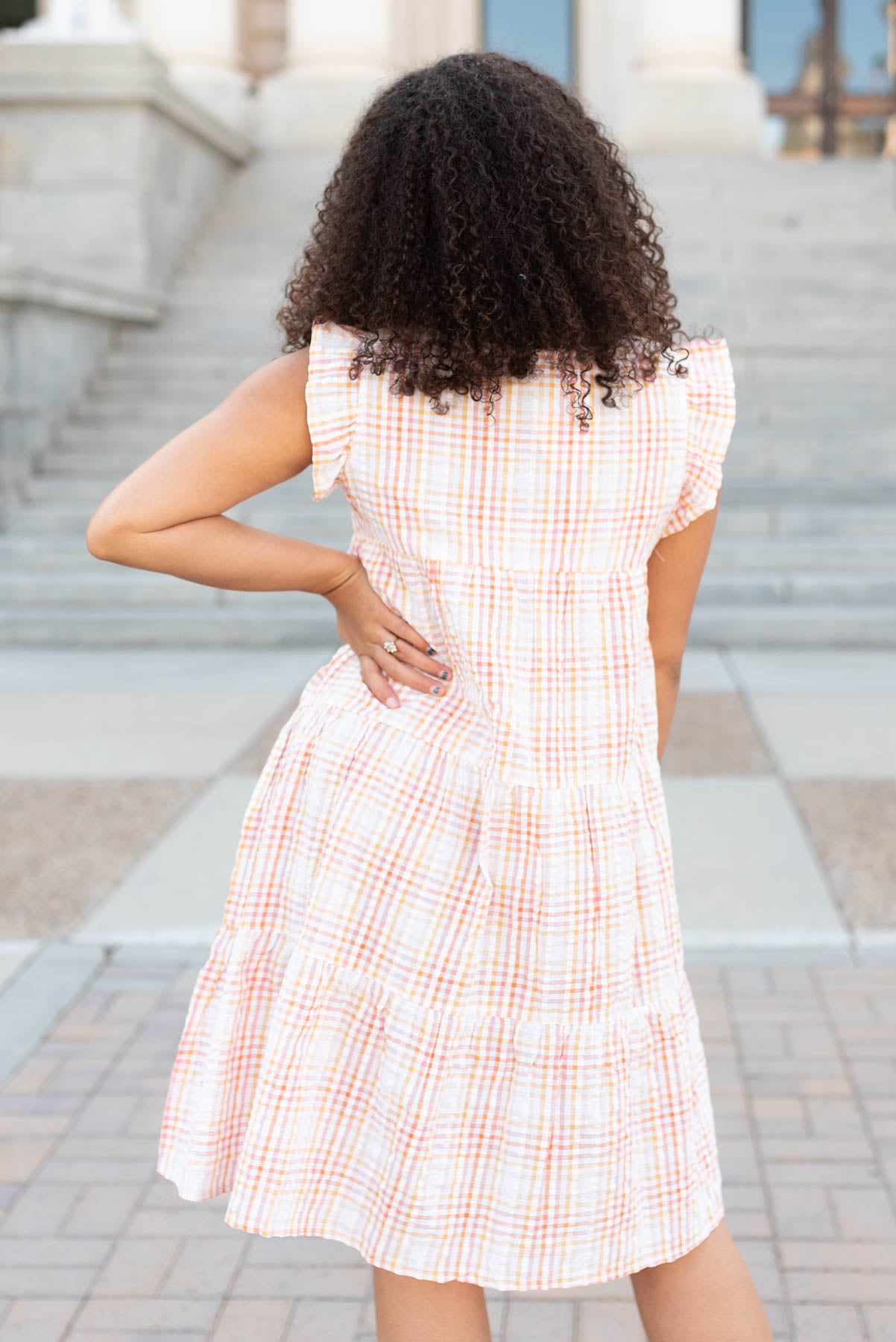 Back view of the orange plaid mini dress