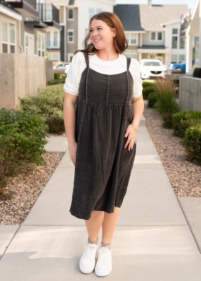 Black wash jumper dress with buttons on the bodice