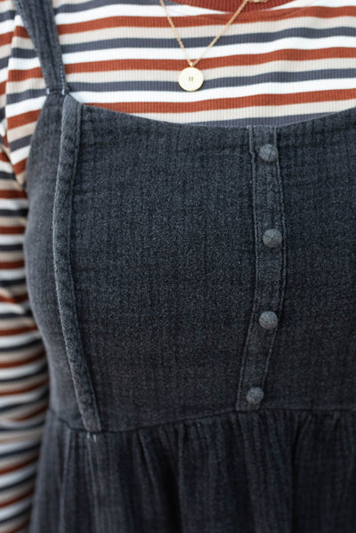 Close up of the bodice and buttons on the black wash jumper dress