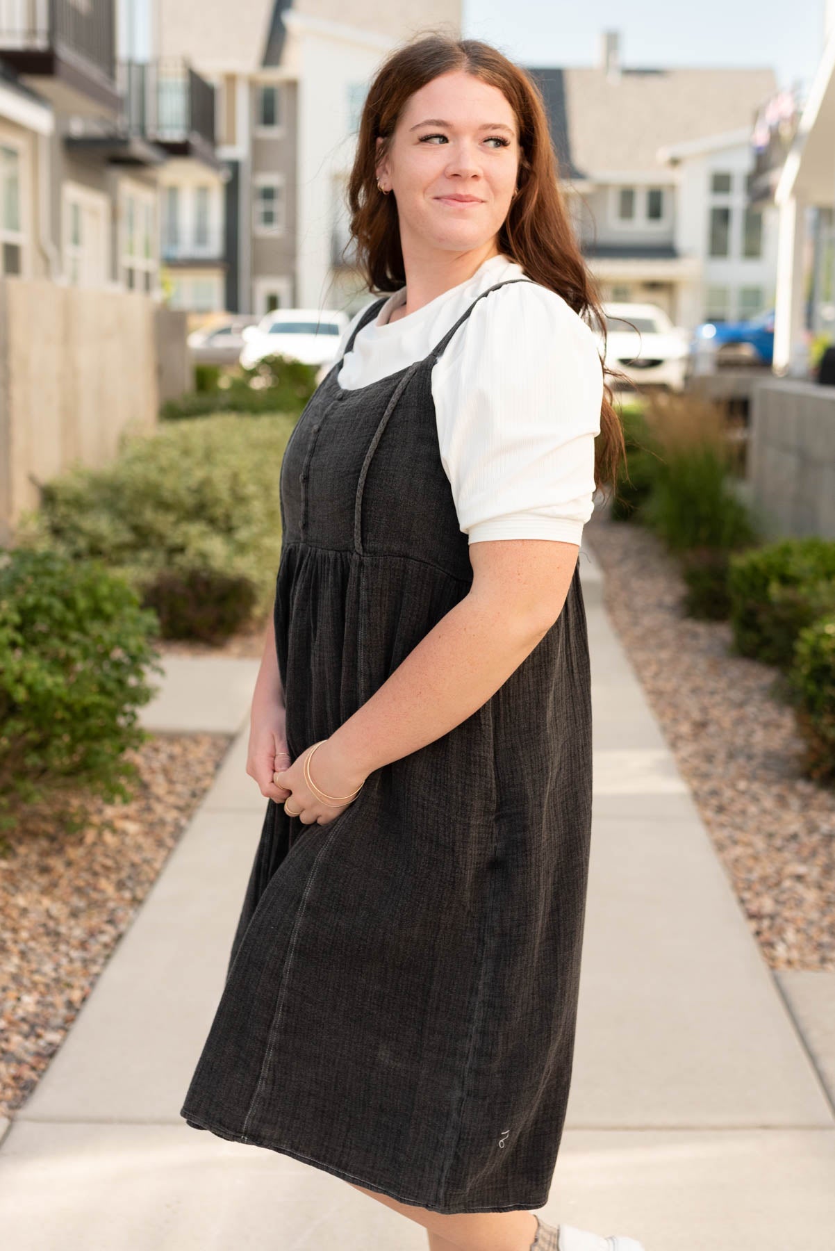 Side view of the the plus size black wash jumper dress