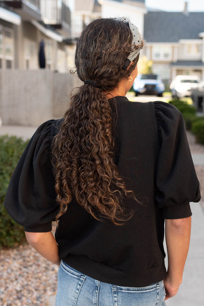 Back view of the black puff sleeve pullover