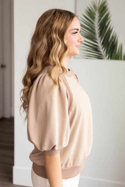 Side view of the taupe puff sleeve pullover