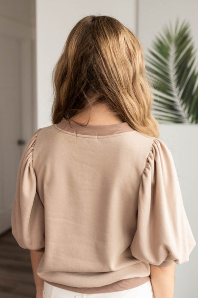 Back view of the taupe puff sleeve pullover