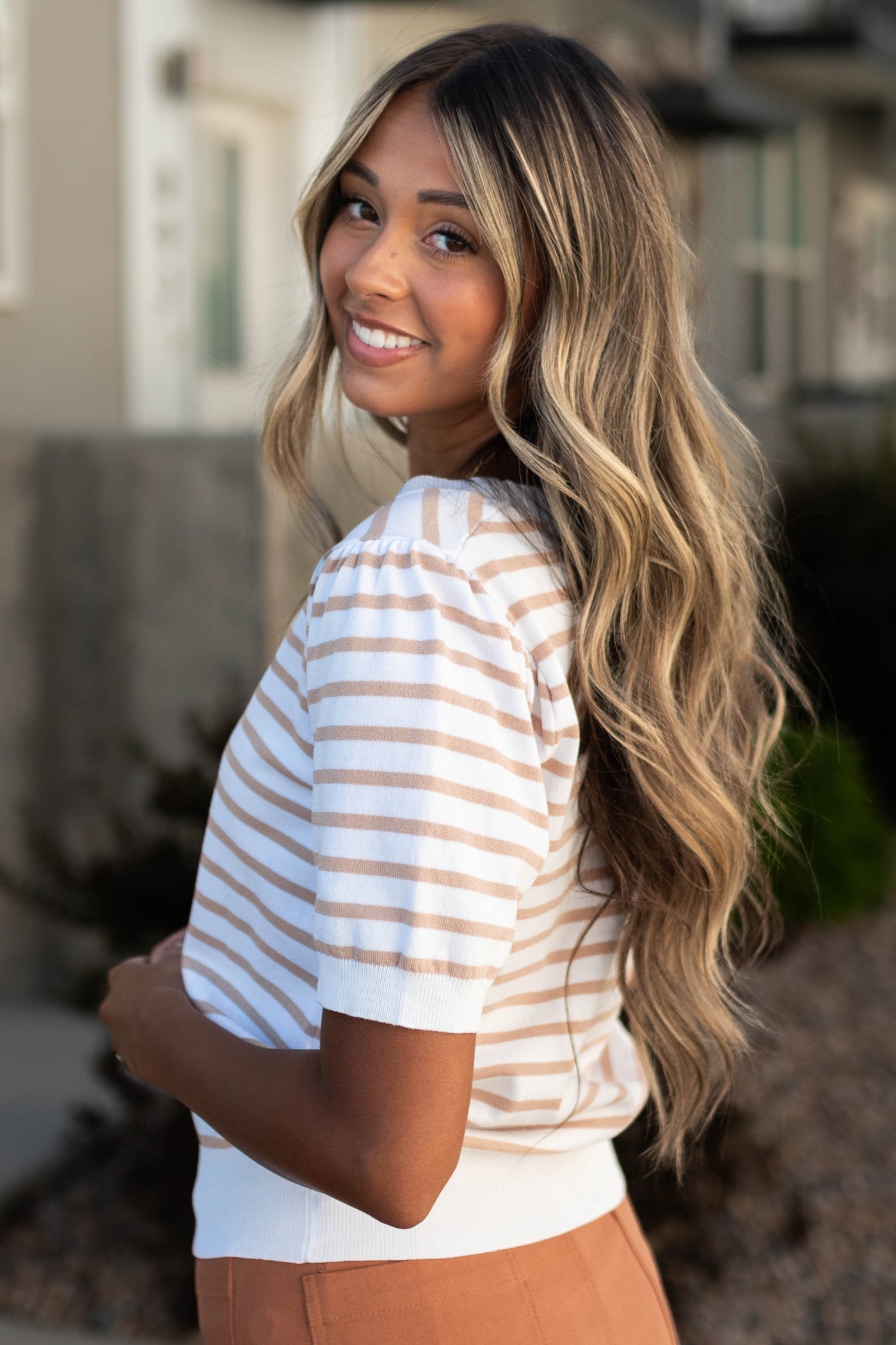 Side view of a taupe striped top