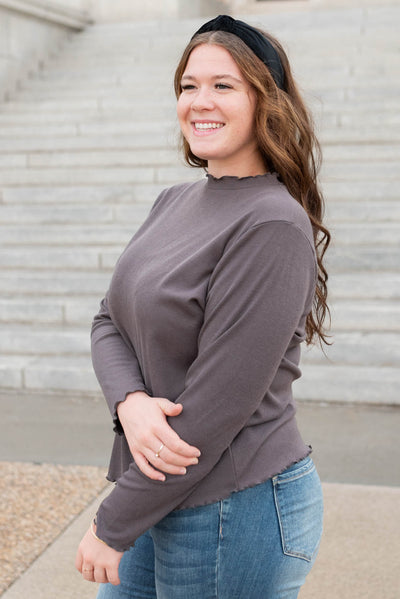 Side view of the plus size charcoal ruffle ribbed top