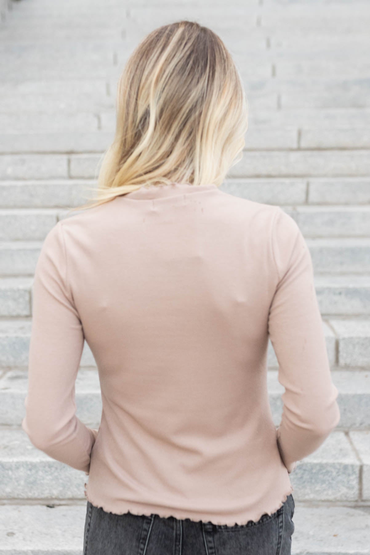 Back view of the tan ruffle ribbed top