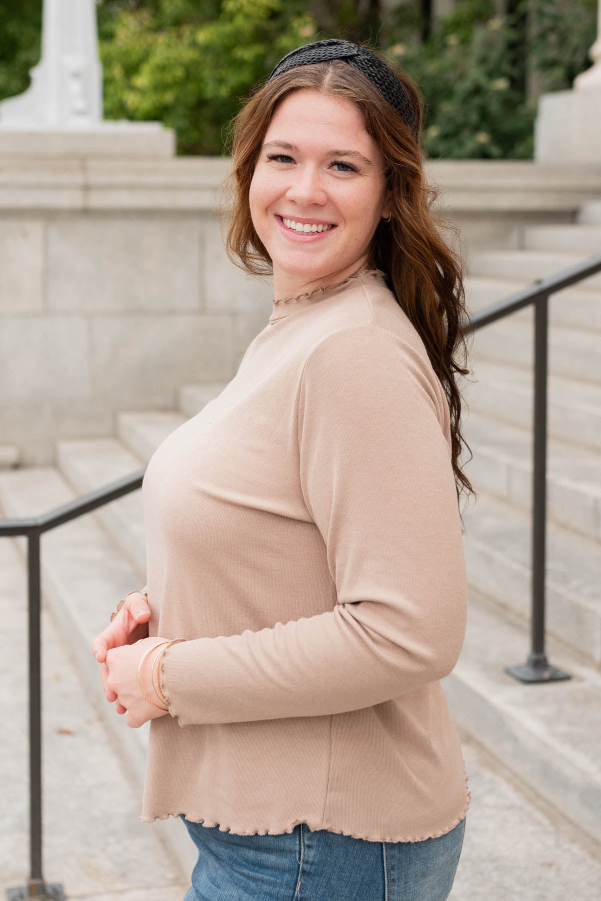 Side view of the tan ruffle ribbed top