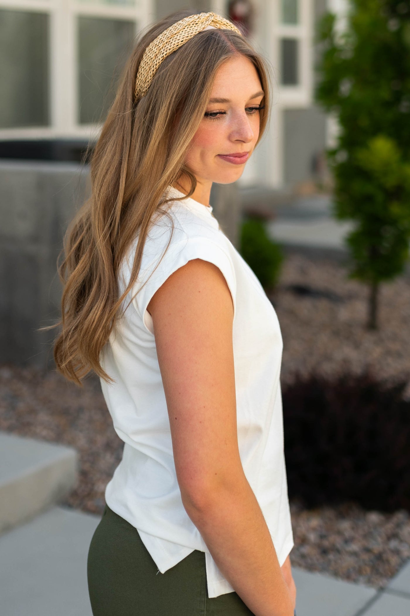 Side view of a white top with cap sleeves