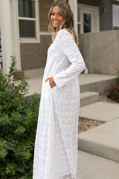 Side view of a white floral dress with pockets