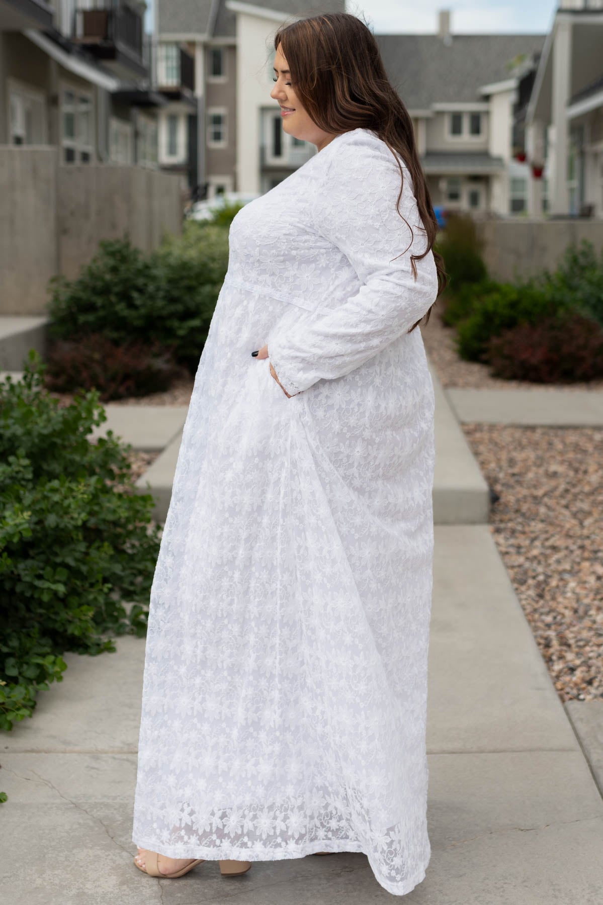 Side view of a long plus size white floral dress