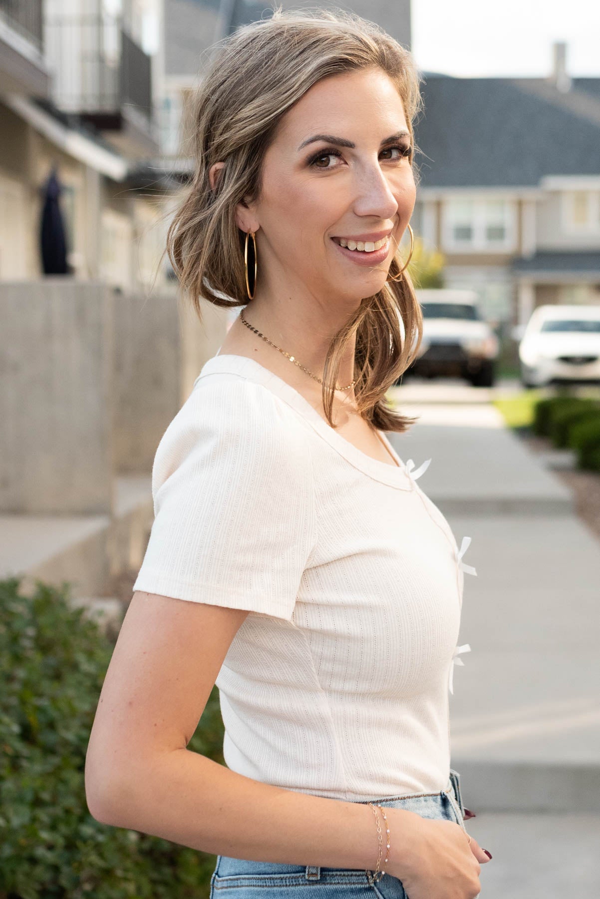 Side view of the cream bow bodysuit