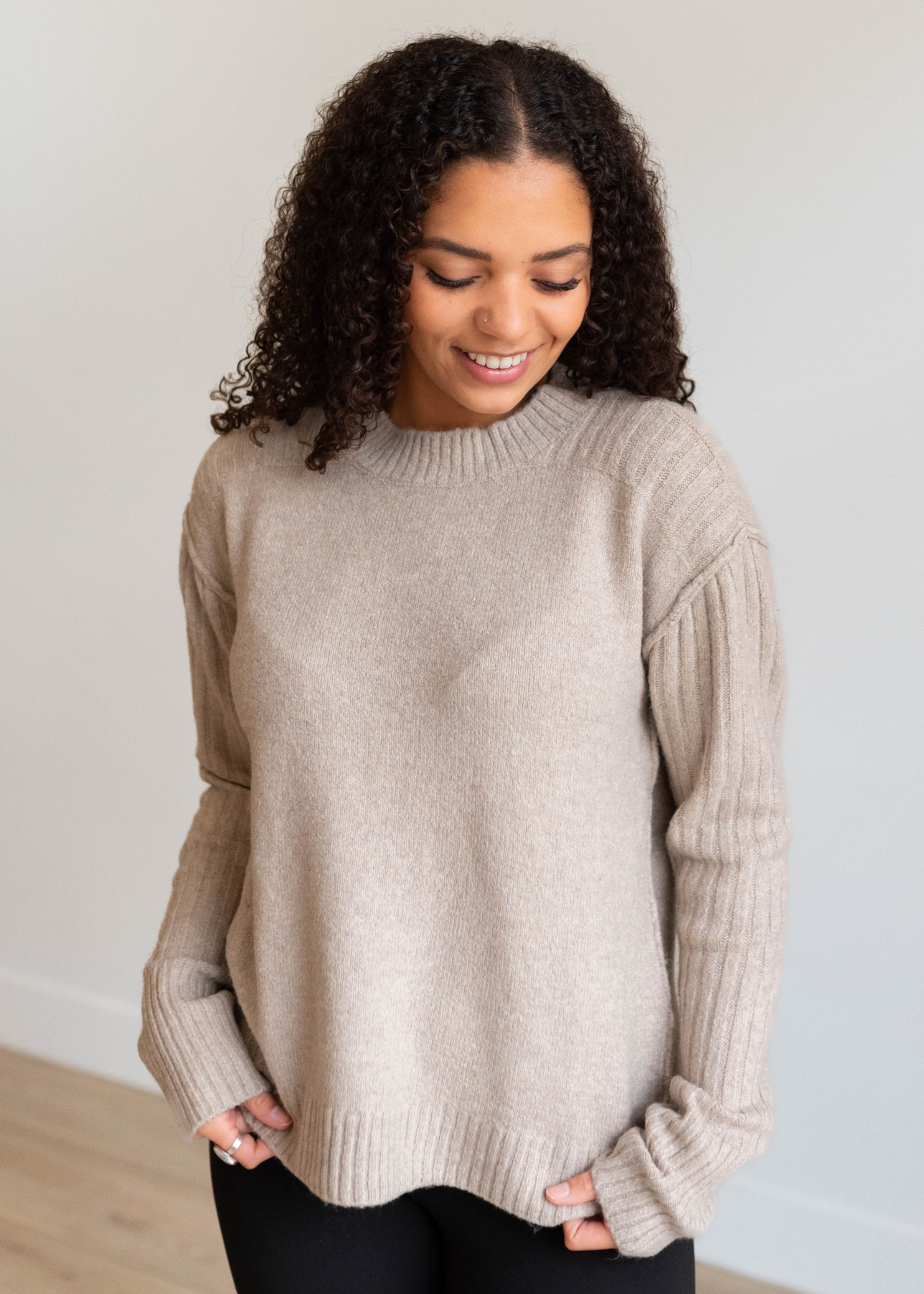 Ribbed sleeves and shoulders on the heather khaki knit sweater