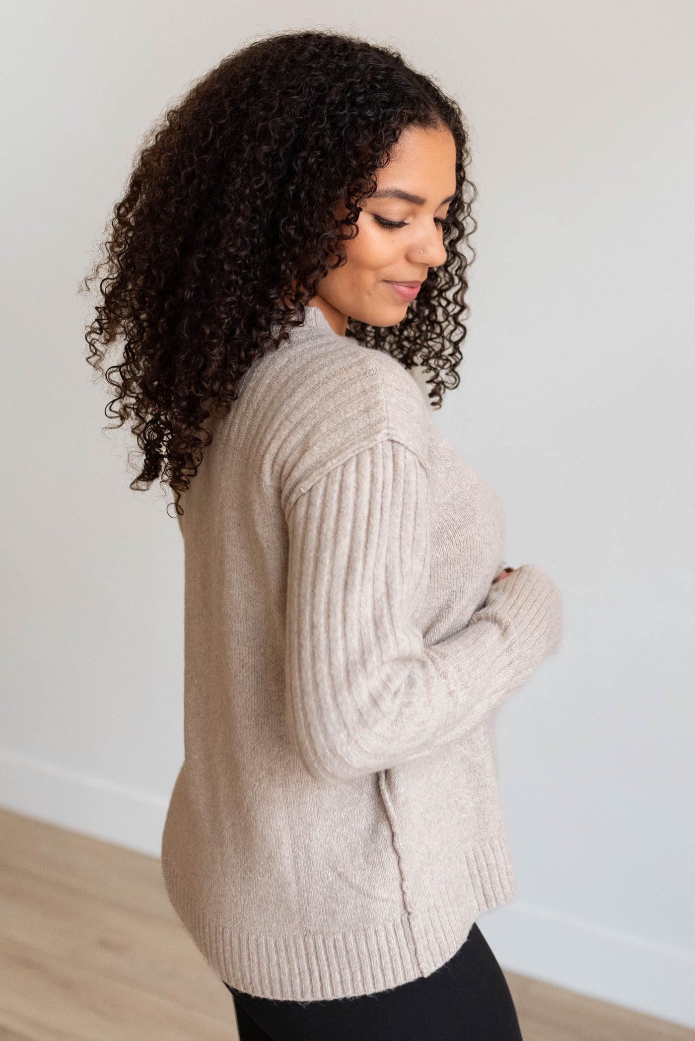 Side view of the heather khaki knit sweater