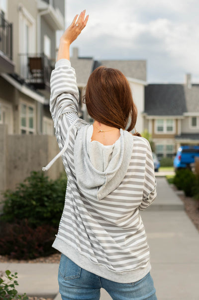 Back view of a long sleeve heather grey hoodie