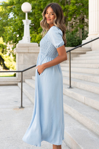 Side view of the blue smocked dress