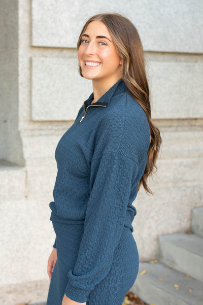 Side view of the navy knit pllover