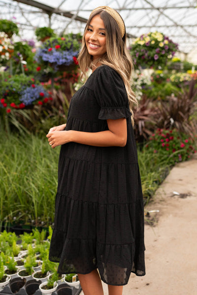 Side view of the black dot midi dress