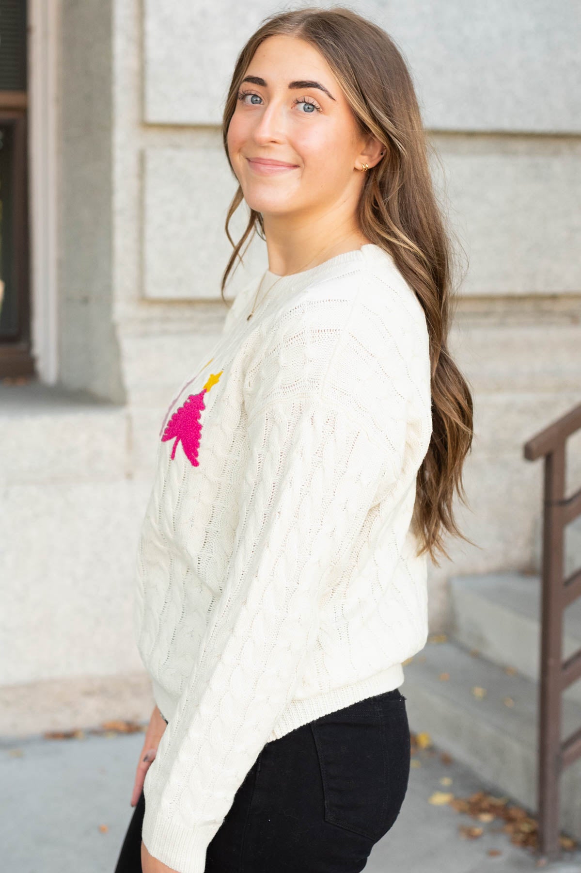 Side view of the cream embroidered tree sweater