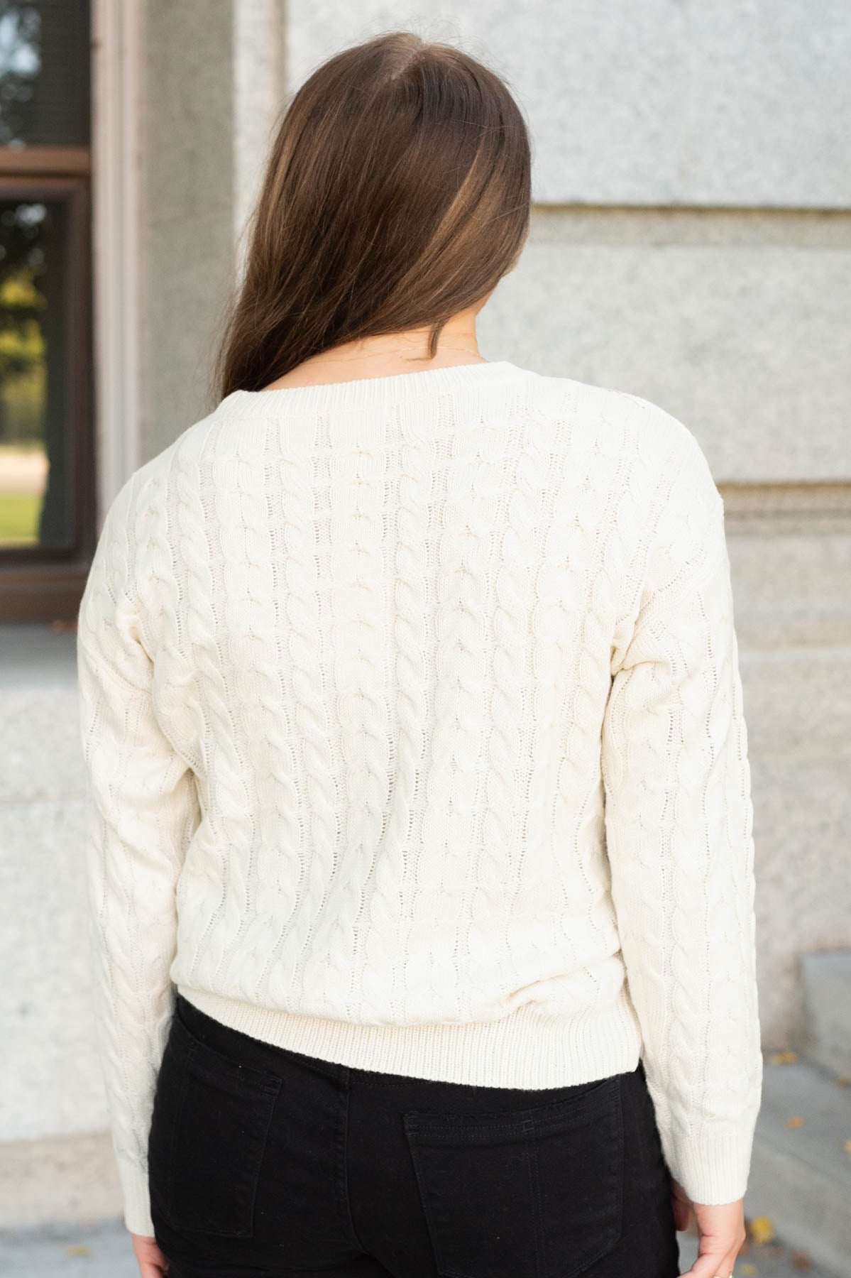 Back view of the cream embroidered tree sweater