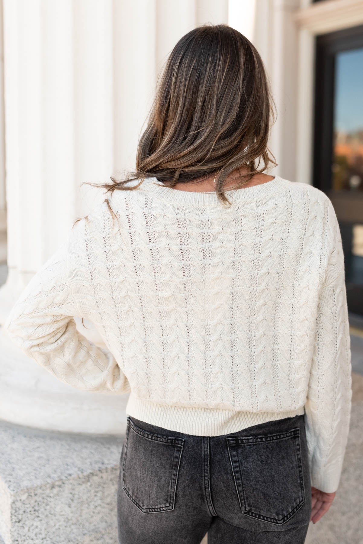 Back view of the cream embroidered tree sweater