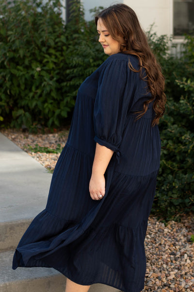 Side view of a plus size navy dress