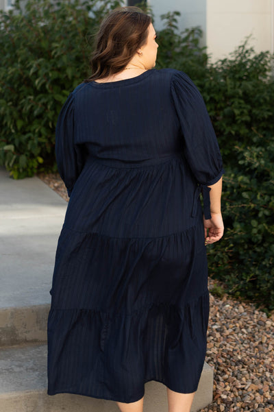 Back view of a plus size navy dress