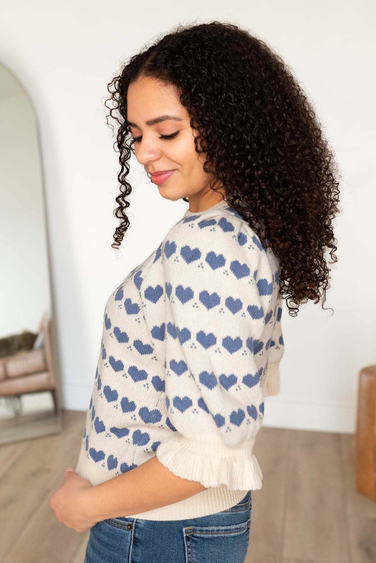 Side  view of the ivory heart stripe sweater with blue hearts