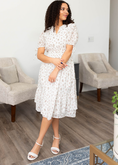 Ivory swiss dot floral dress with short sleeves and bows on the cuffs