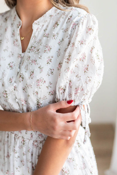 Close up of the fabric and sleeve on the ivory swiss dot floral dress