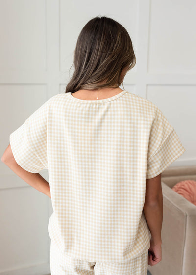 Back view of the beige gingham knit top