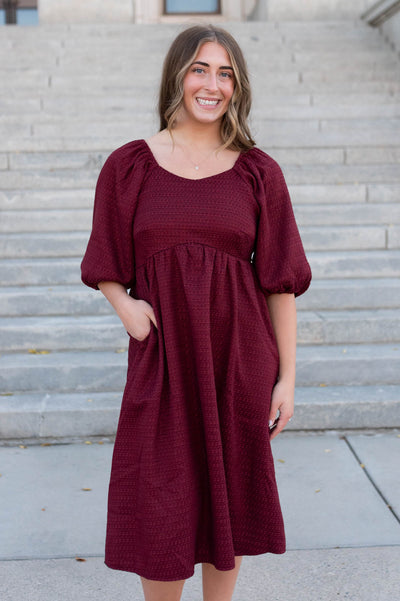 Burgundy textured dress with pocket and puff sleeves