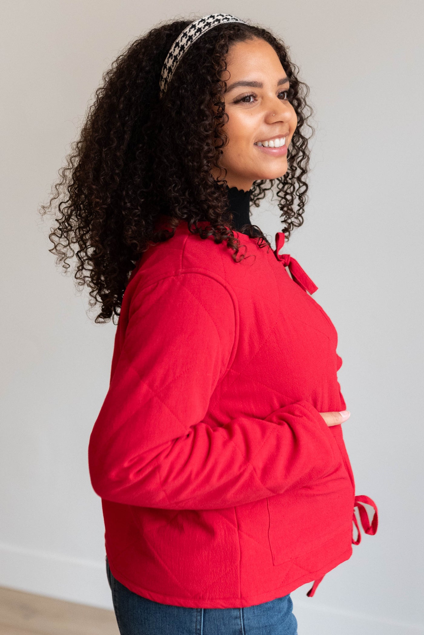 Side view of the red quilted tie jacket