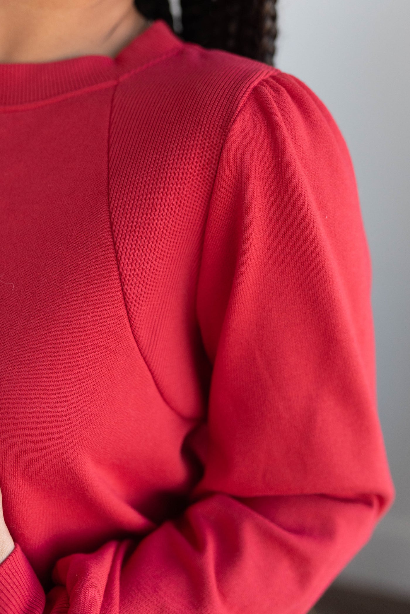 Red pullover with gathering on the shoulders