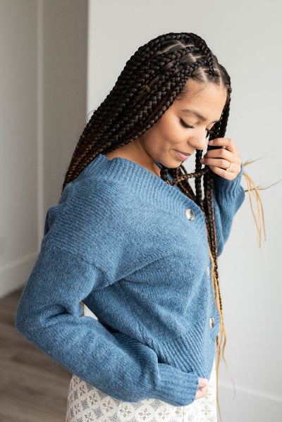 Side view of the dusty blue button down cardigan