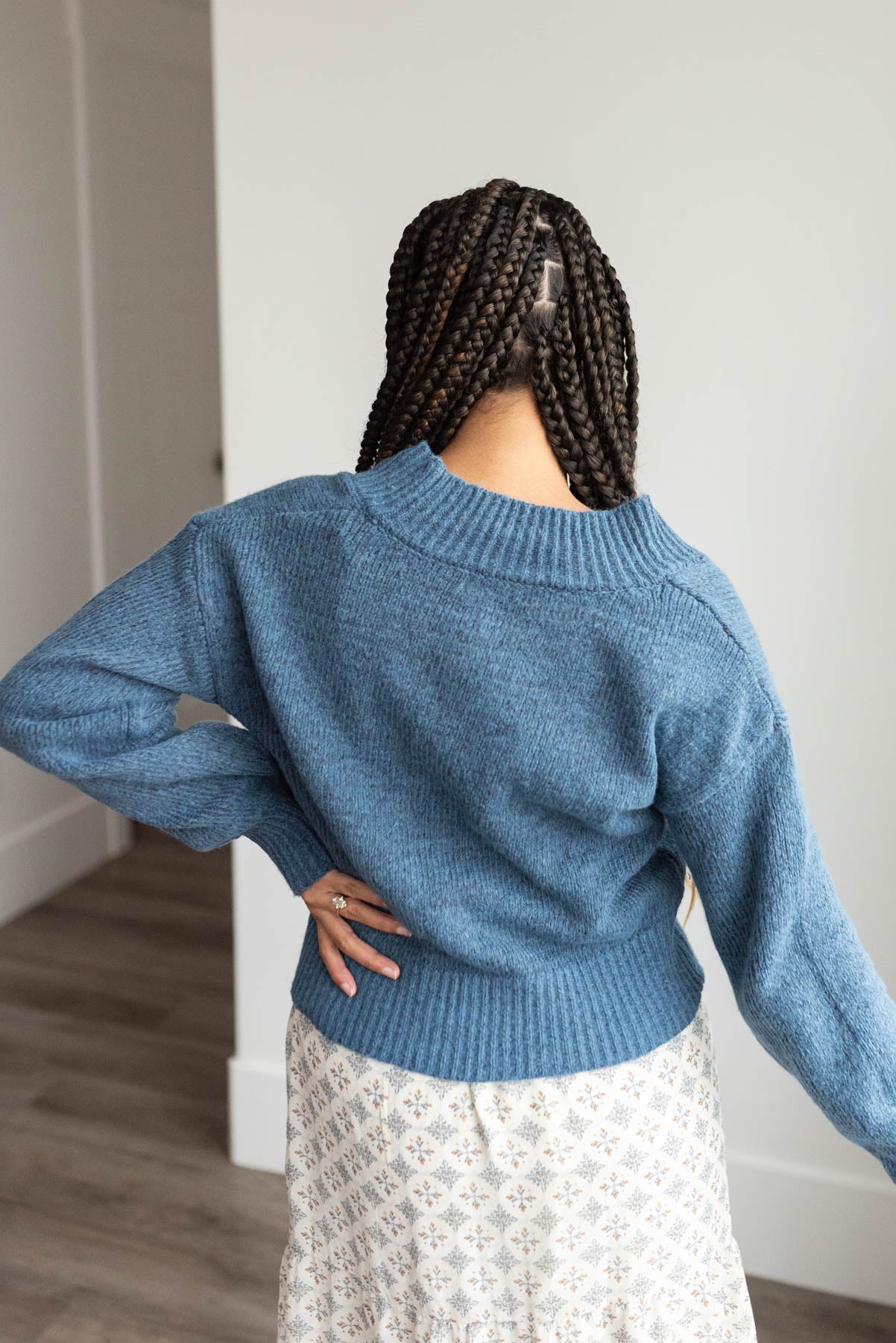 Back view of the dusty blue button down cardigan